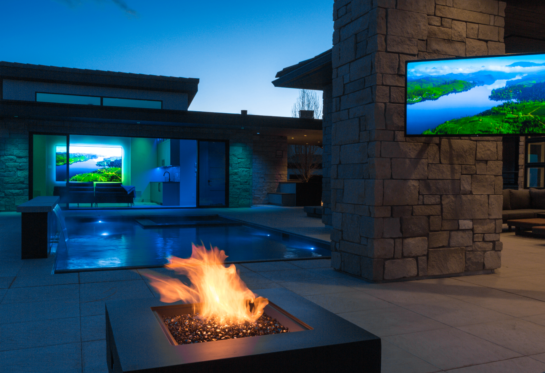 Outdoor pool and fire pit with integrated television