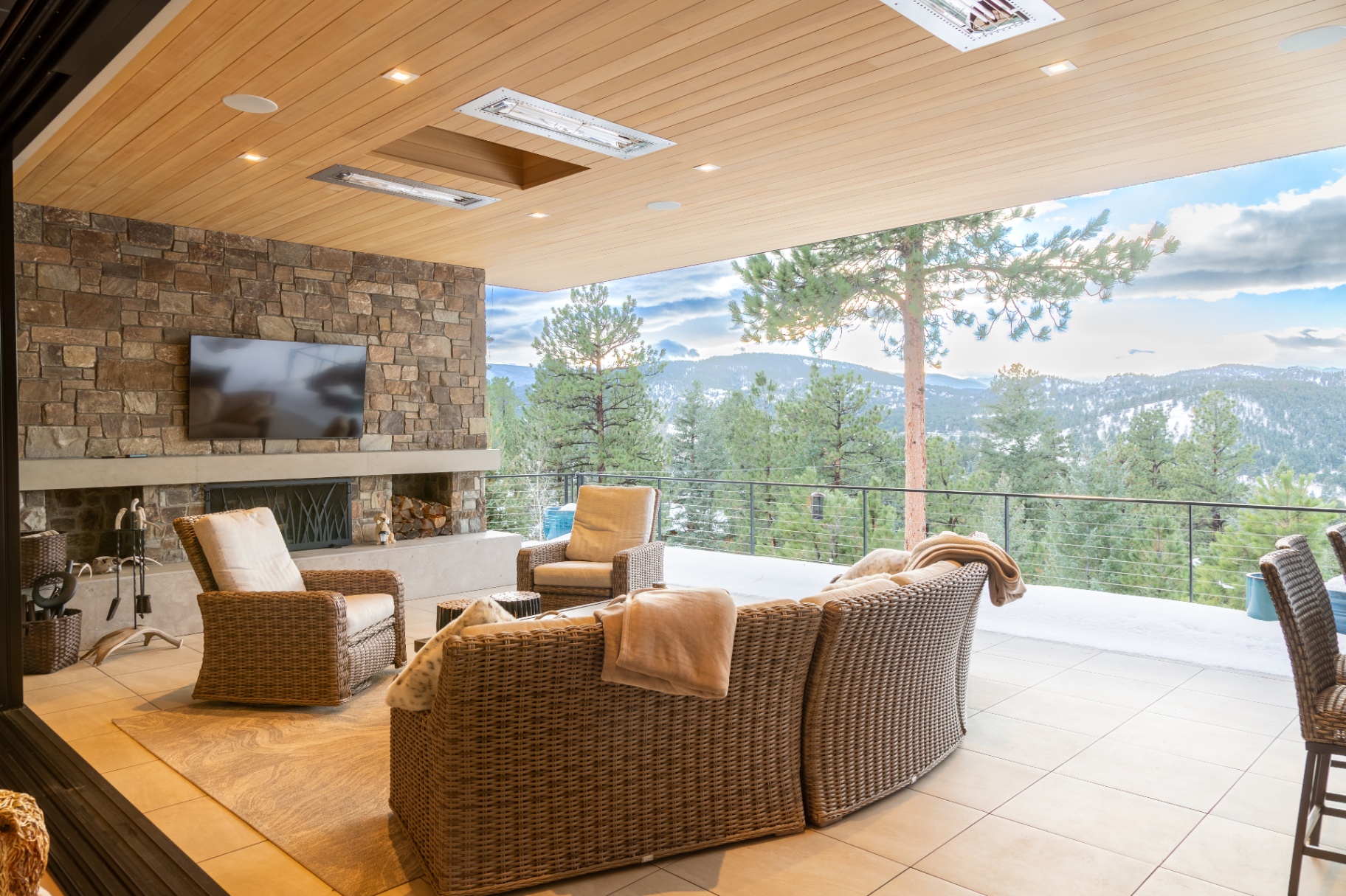 Mountain-view deck with outdoor television and fireplace in Evergreen, Colorado